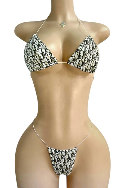 Bikini set with black and white pattern on a mannequin against a white background