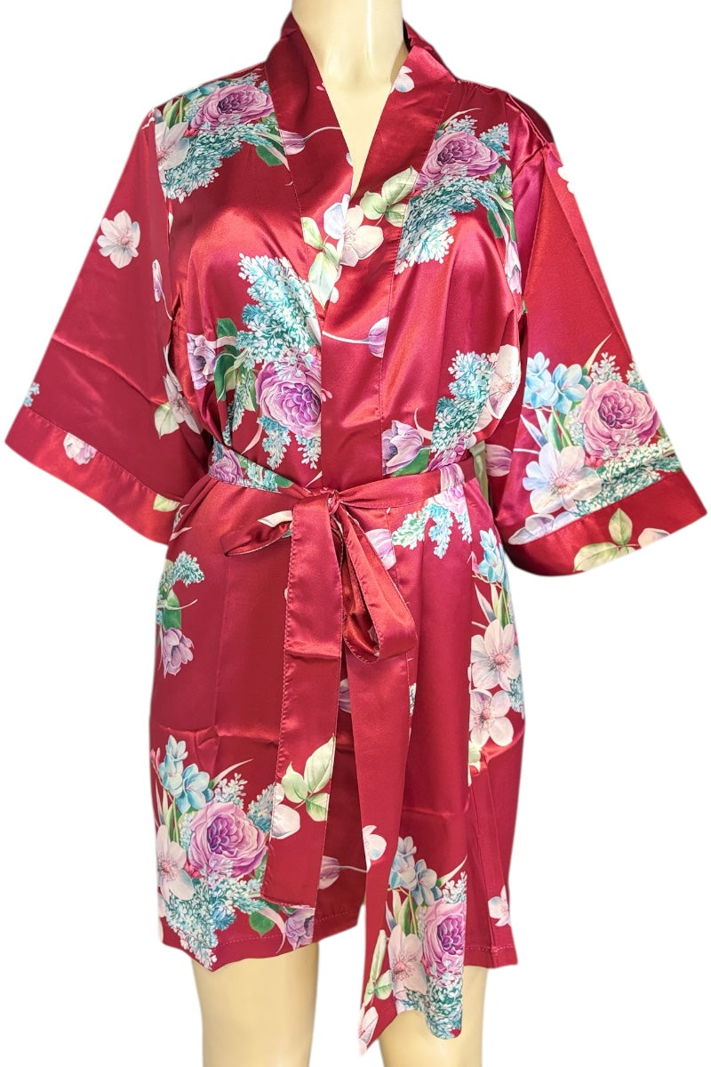 Red satin robe with floral patterns on a mannequin against a white background