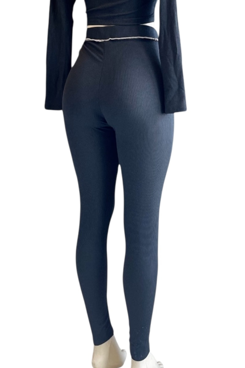 black leggings worn by a person on a white background