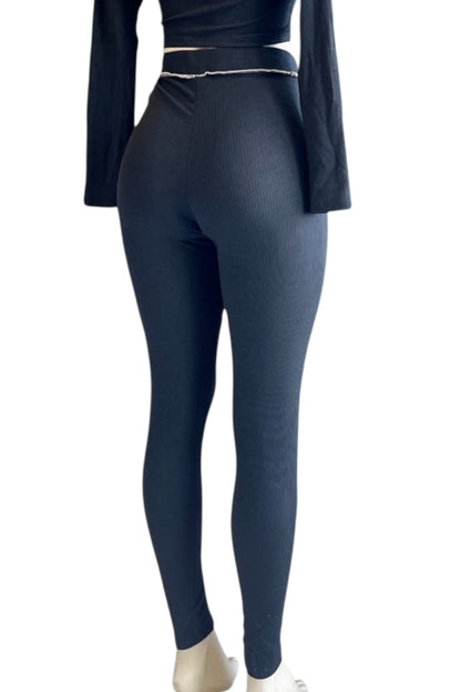 black leggings worn by a person on a white background