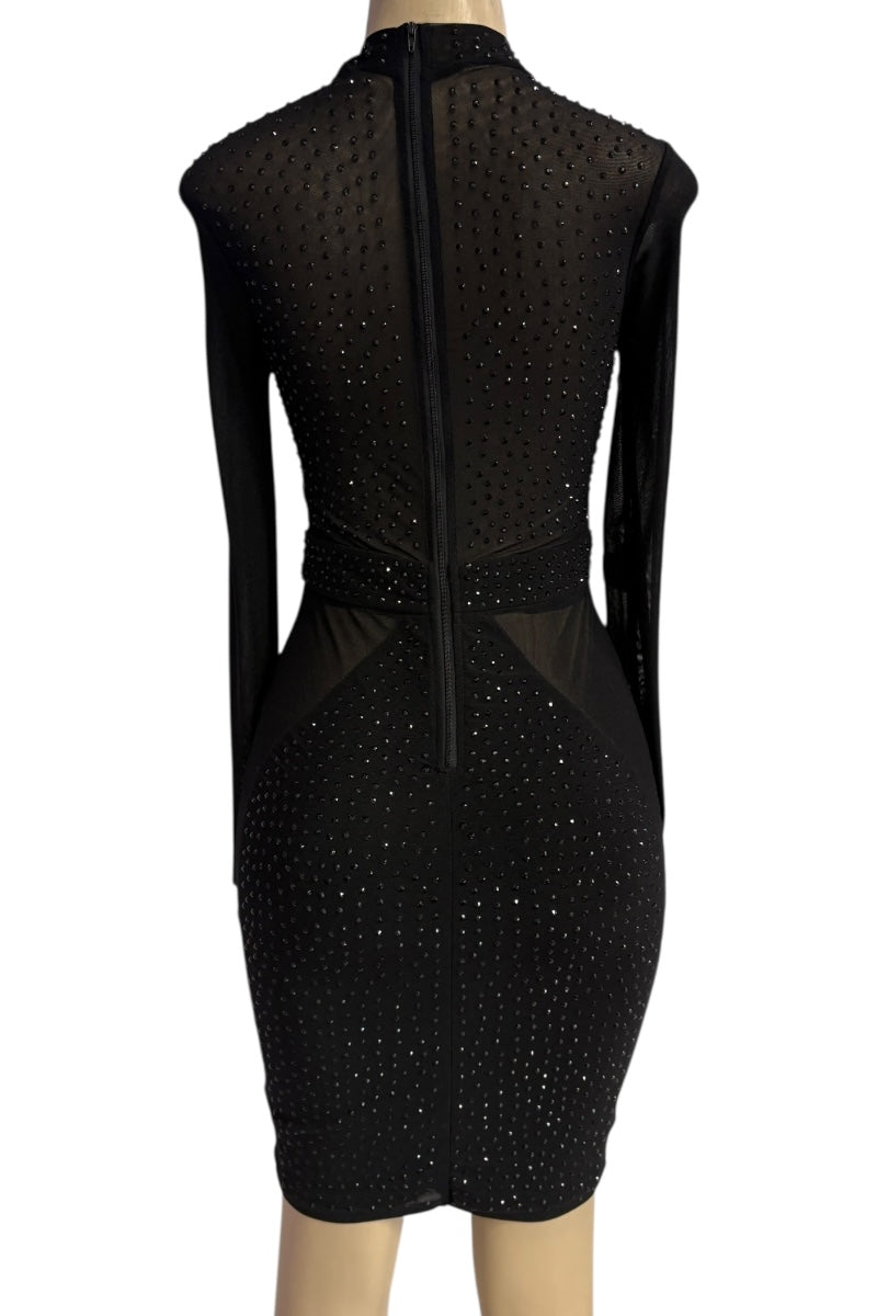 Black dress with sheer panels on a mannequin against a white background