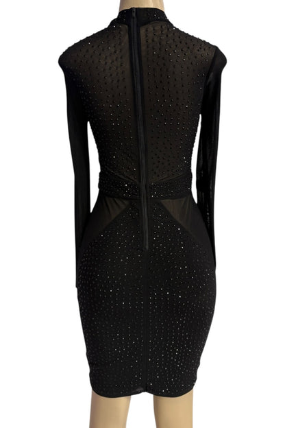 Black dress with sheer panels on a mannequin against a white background
