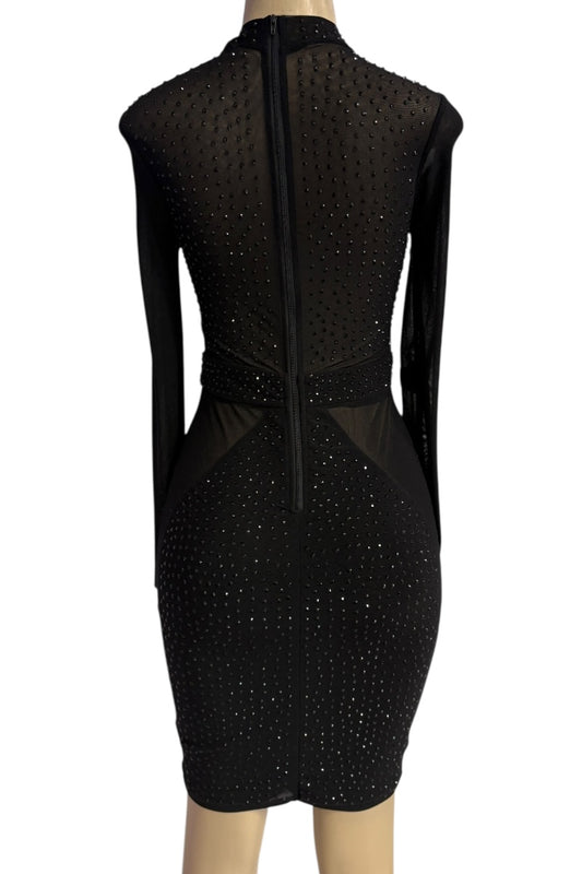 Black dress with sheer panels on a mannequin against a white background
