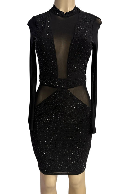 Black dress with sheer panels on a mannequin against a white background
