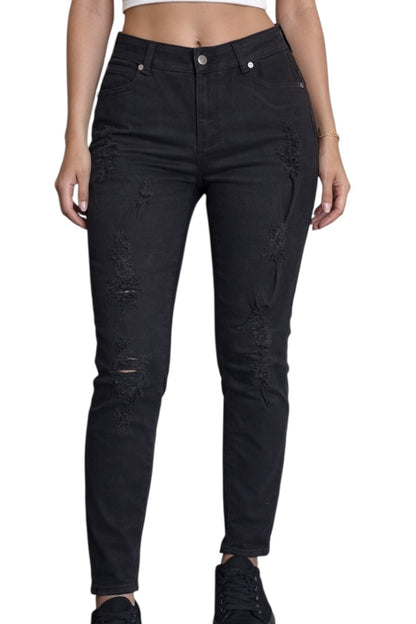 Black distressed jeans worn by a person on a white background