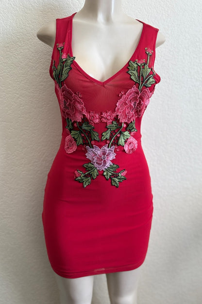 Red dress with floral embroidery on a mannequin against a white background