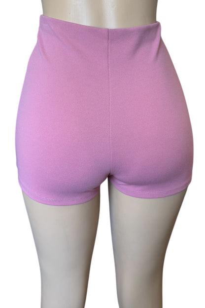 Pink shorts on a mannequin with a white background