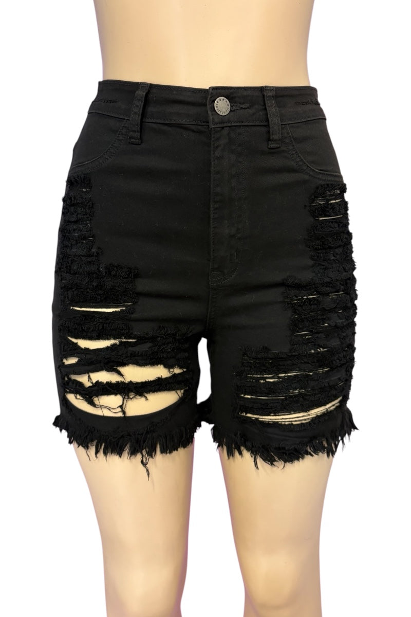 Black high-waisted distressed denim shorts with heavy ripped detailing and frayed hems, shown on a mannequin torso against a white background.