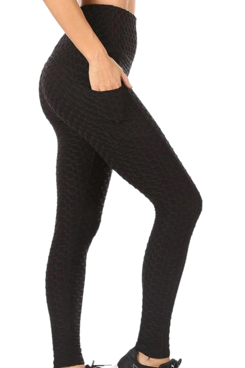Black textured leggings worn by a person on a white background