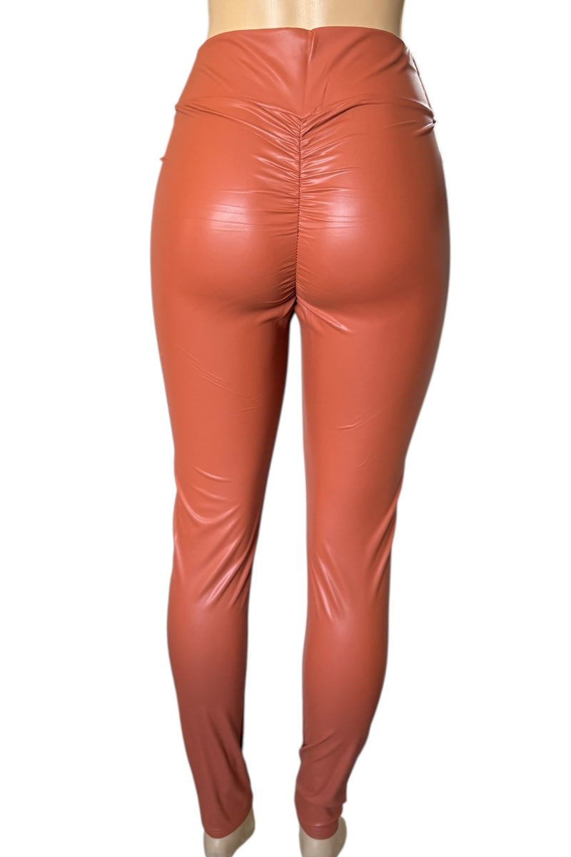 Rust shiny leggings on a white background