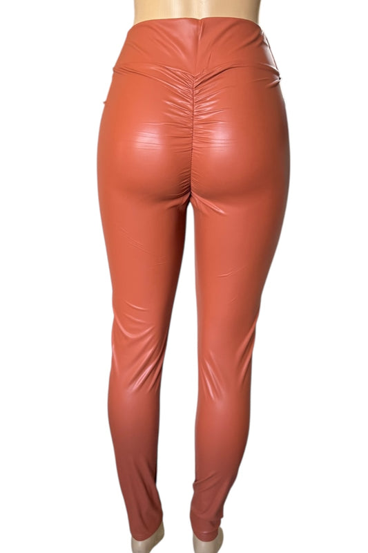 Rust shiny leggings on a white background