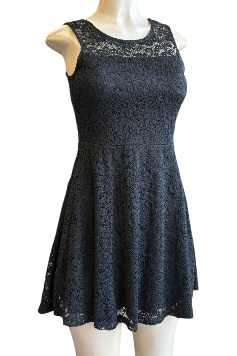 Black lace dress on a mannequin against a white background
