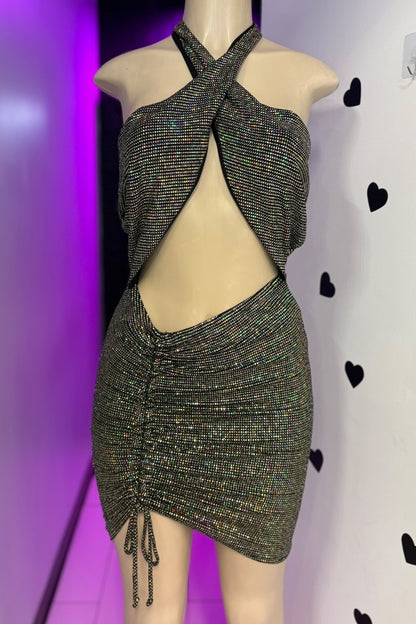 Mannequin wearing a sparkly halter dress against a purple and white background with heart shapes.