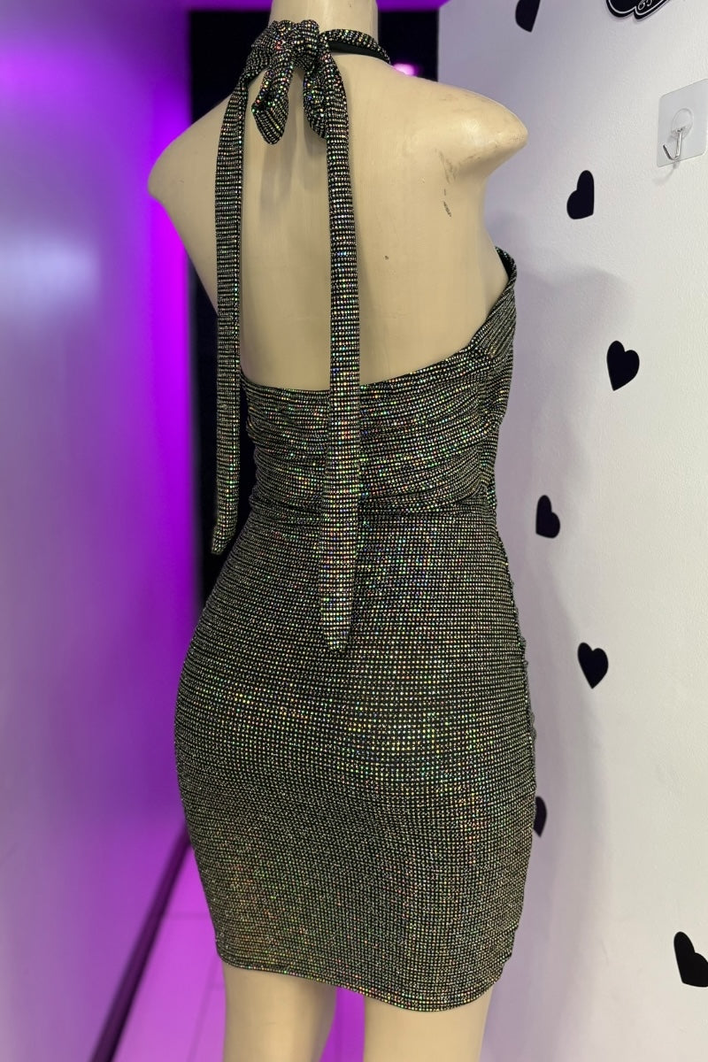Mannequin wearing a sparkly dress with a purple and white background