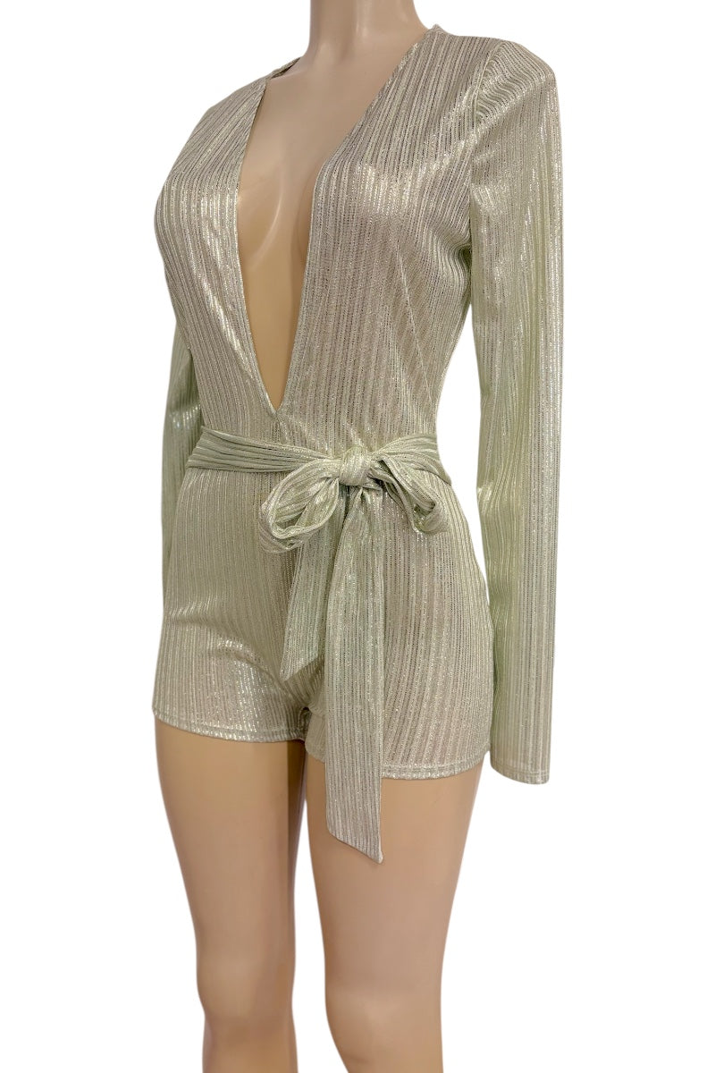 A metallic long-sleeve romper with a deep plunging V-neckline, vertical pleated texture, and a matching waist tie, displayed on a mannequin against a white background.