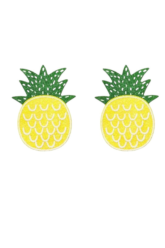 Pineapple-shaped pasties with green leaves on a white background
