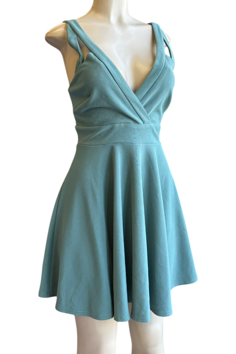 Teal dress on a mannequin against a white background