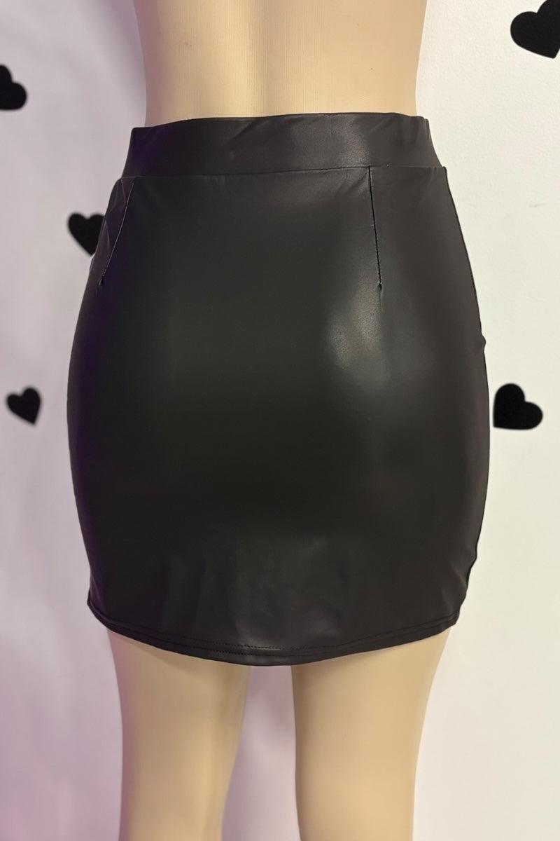Black leather skirt on a mannequin against a light background