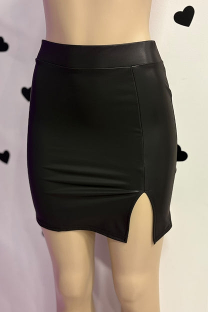 Black leather skirt on a mannequin with a plain background