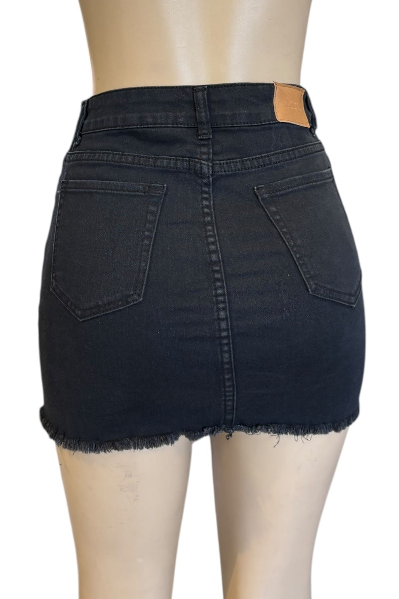 Black denim skirt on a mannequin with a white background