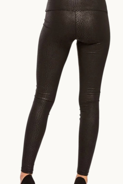 Black leather leggings with snake print on a white background