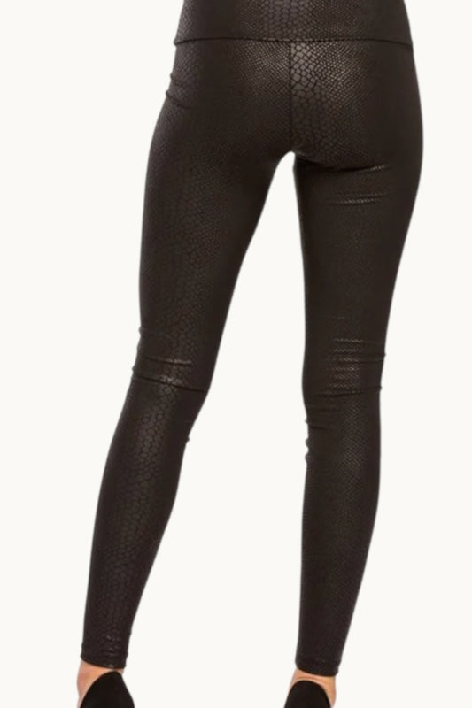 Black leather leggings with snake print on a white background