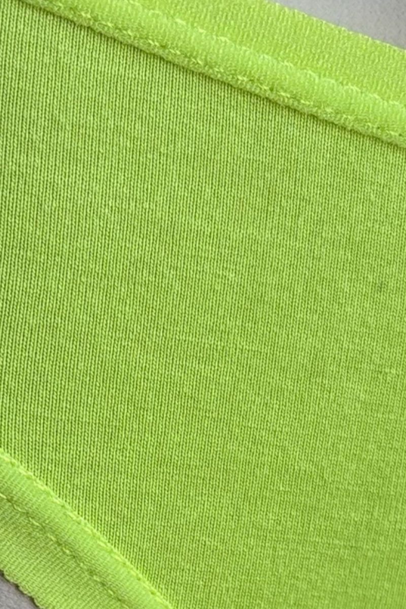 Close-up of neon green fabric with a visible seam