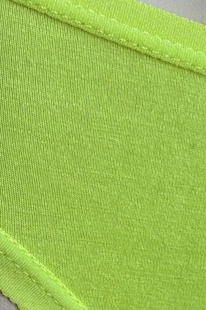 Close-up of neon green fabric with a visible seam