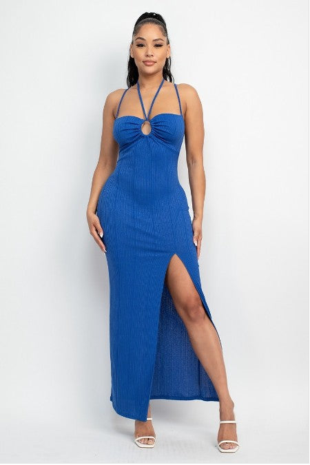 Woman wearing a blue dress with a high slit on a white background