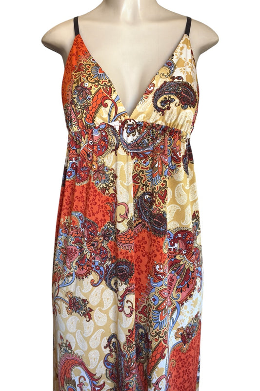 Colorful patterned dress on a mannequin against a white background