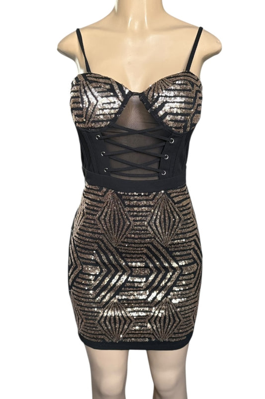 Black and gold sequin dress on a mannequin against a white background