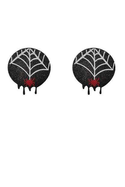 Black spiderweb-shaped pasties with red centers on a white background
