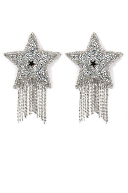 Star-shaped pasties with fringe details on a white background