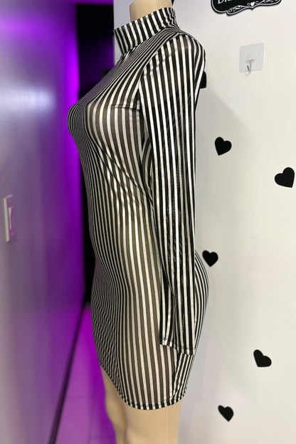 Black and silver striped dress on a mannequin against a white background with black heart shapes.