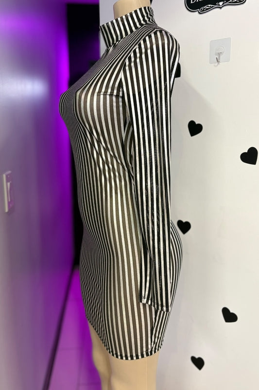 Black and silver striped dress on a mannequin against a white background with black heart shapes.