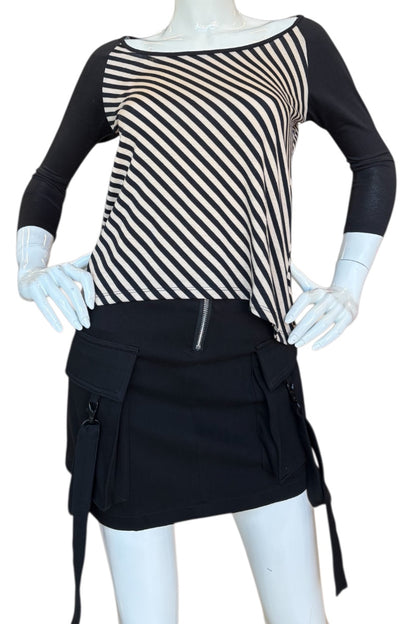 Mannequin wearing a black and beige striped top with a black skirt on a white background