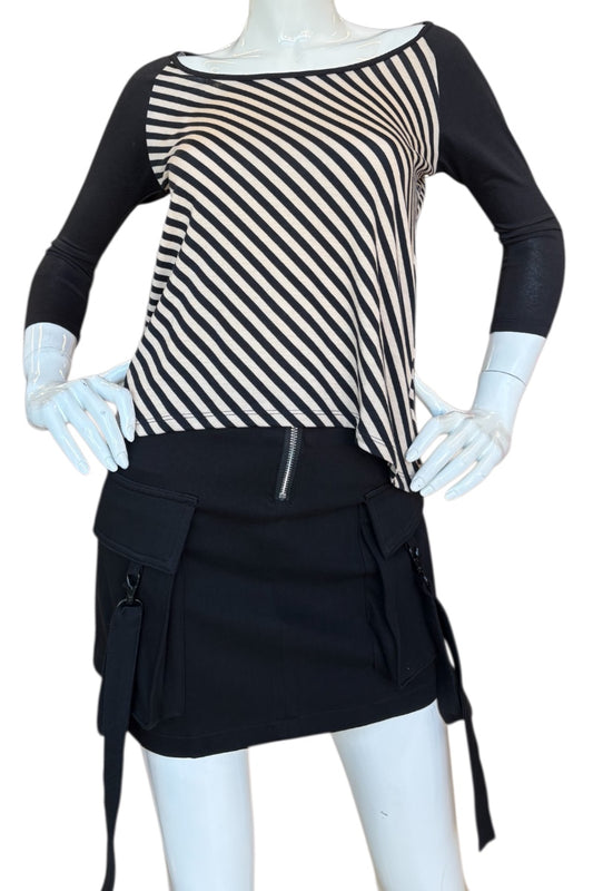 Mannequin wearing a black and beige striped top with a black skirt on a white background