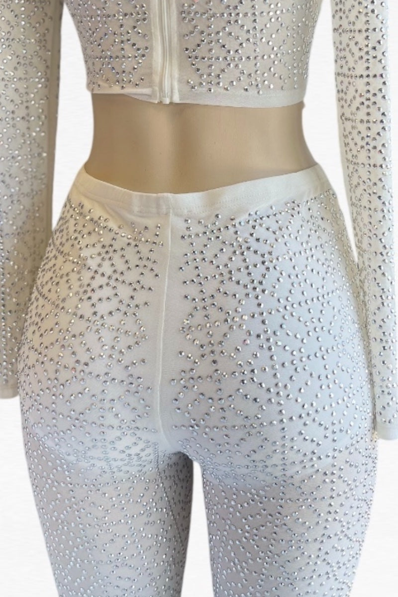 White outfit with long sleeves and rhinestone embellishments on a mannequin.