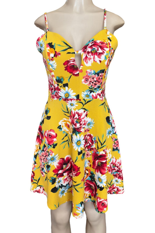 Yellow floral dress on a mannequin against a white background