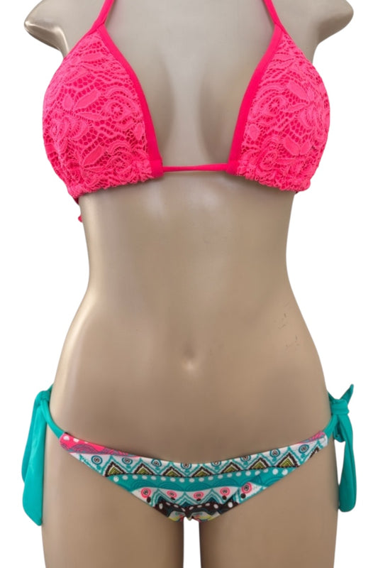 Mannequin wearing a pink lace bikini with a colorful patterned bottom on a white background