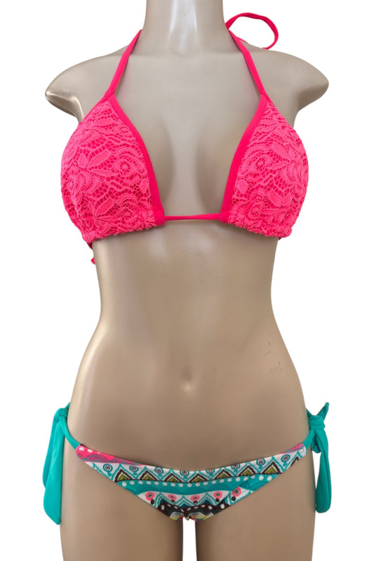 Mannequin wearing a pink lace bikini top and turquoise patterned bottom on a white background