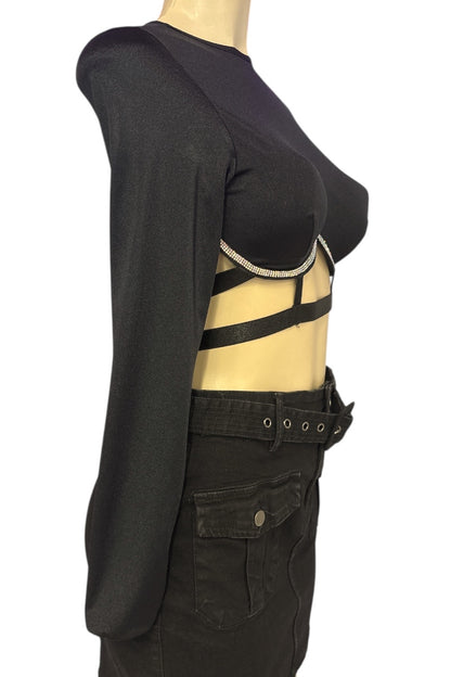 Mannequin wearing a black outfit with cut-out design on a white background