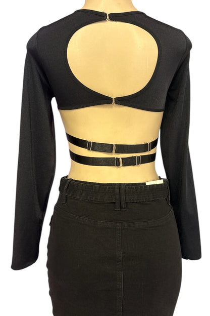 Black long-sleeve top with cut-out design on a mannequin against a white background