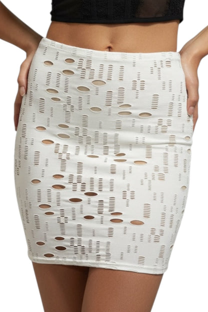 White lace skirt with cut-out pattern worn by a person on a white background