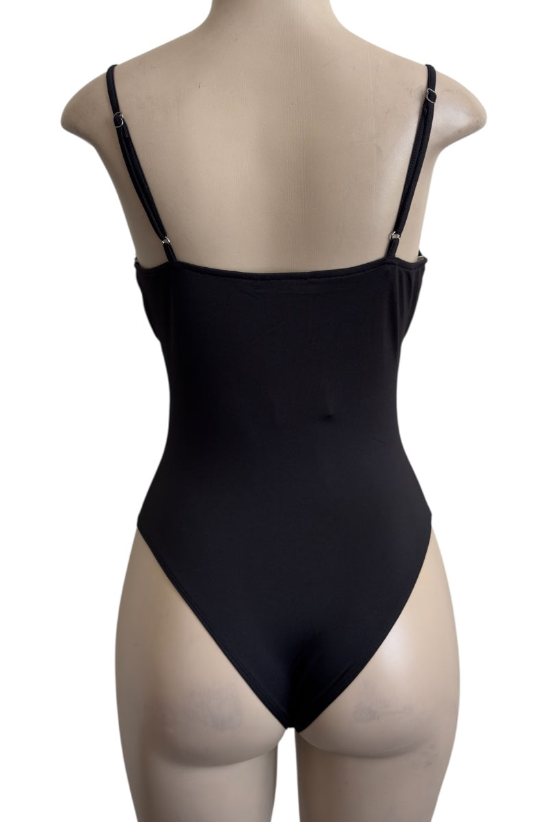 Black bodysuit on a beige mannequin against a white background