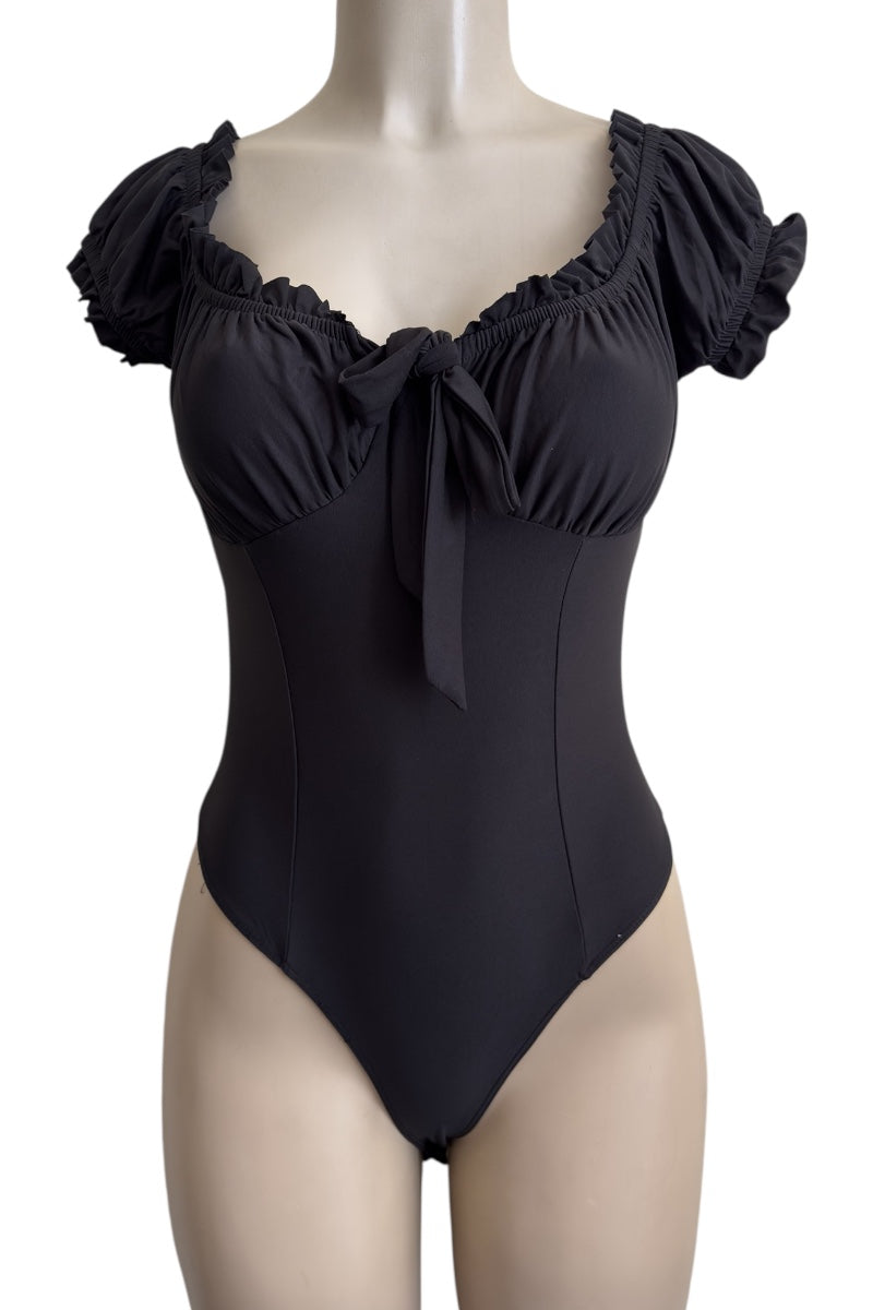 Black bodysuit with ruffled shoulders on a mannequin against a white background