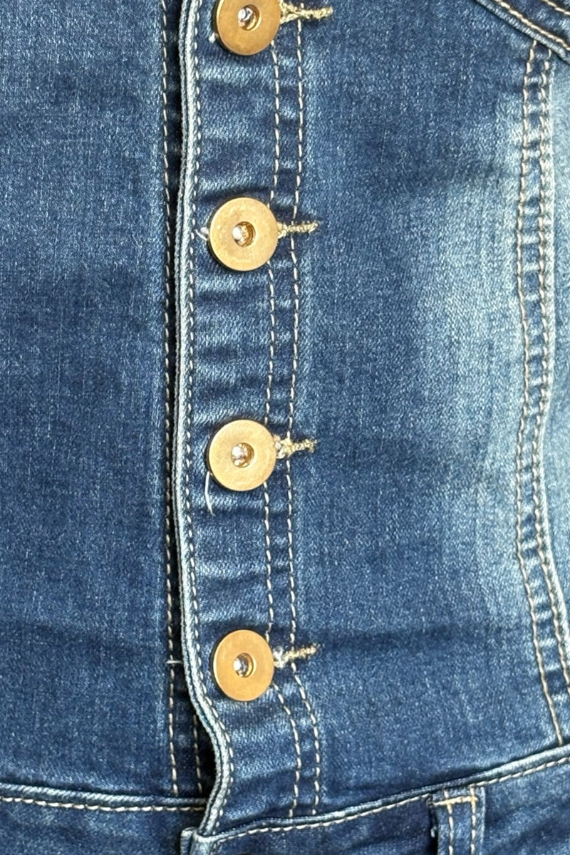 Close-up of a blue denim dress with gold buttons
