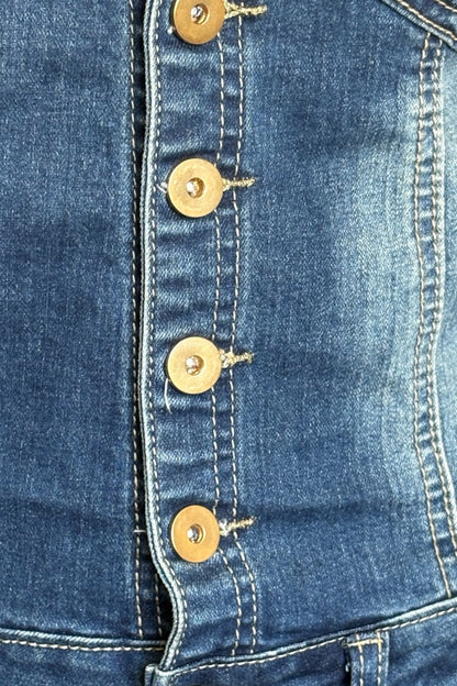 Close-up of a blue denim dress with gold buttons