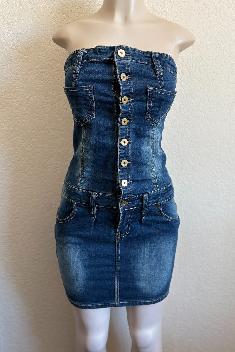 Denim dress with button details on a mannequin against a plain background