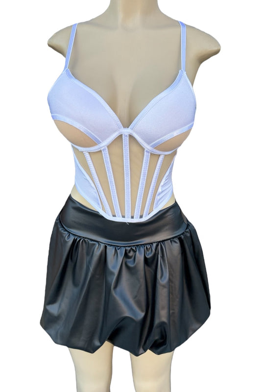 White corset-style top with thin straps and black leather skirt on a mannequin against a white background.